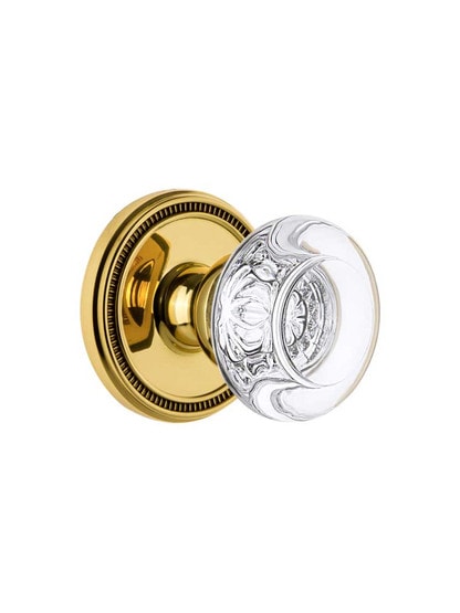 Grandeur Soleil Rosette Door Set with Bordeaux Crystal-Glass Knobs in Polished Brass.